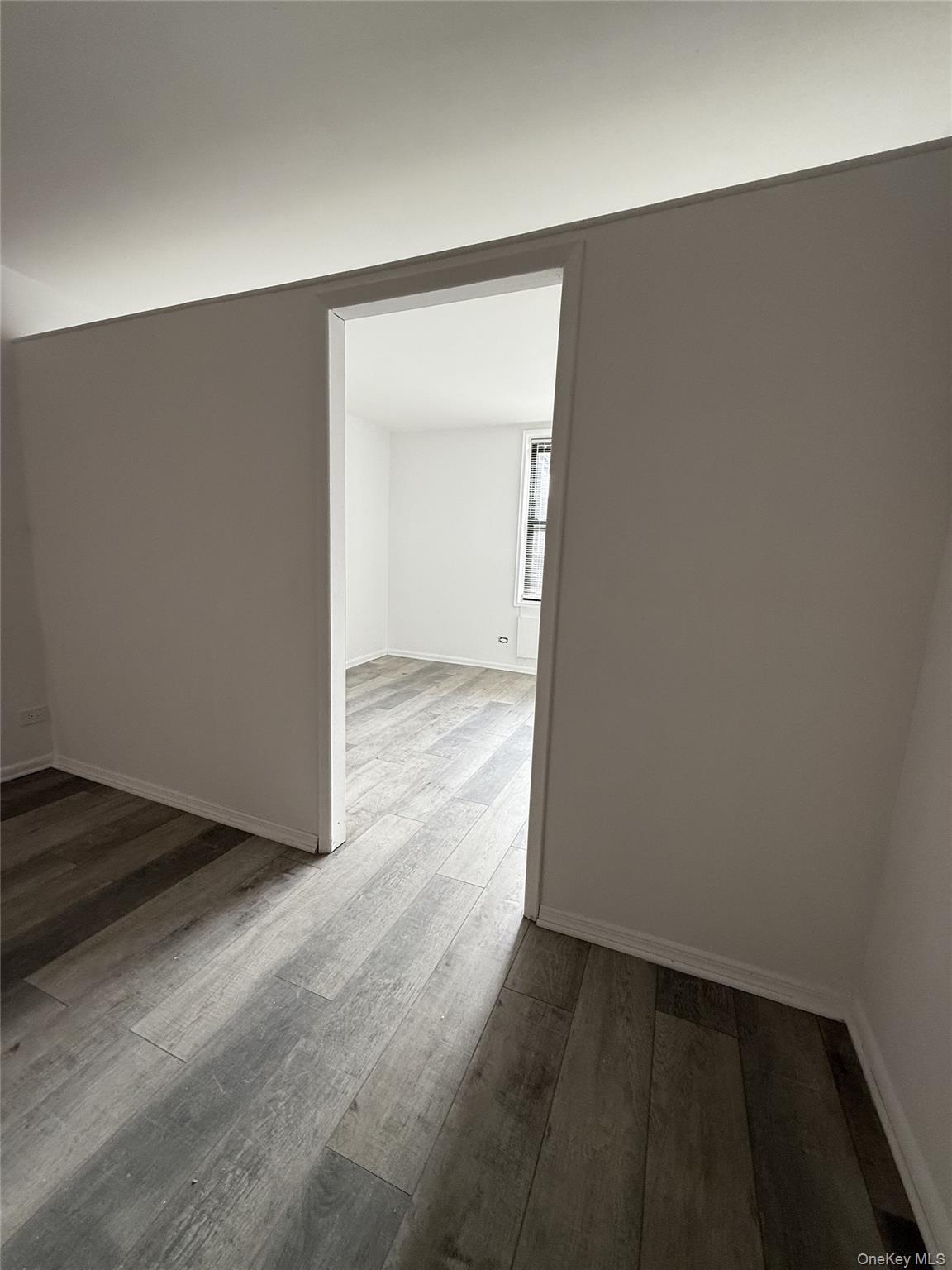 83-30 Vietor Avenue, Unit 727 Queens, NY 11373 - Photo 4 of 11 an empty room with wooden floor