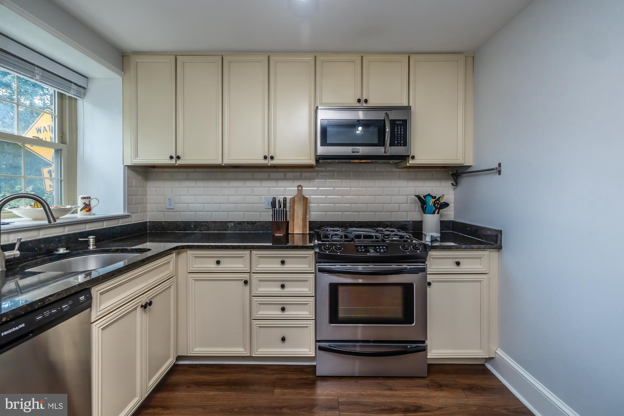 212 Idris Road, Unit Z1 Merion Station, PA 19066 - Photo 19 of 35 a kitchen with granite countertop white cabinets and stainless steel appliances