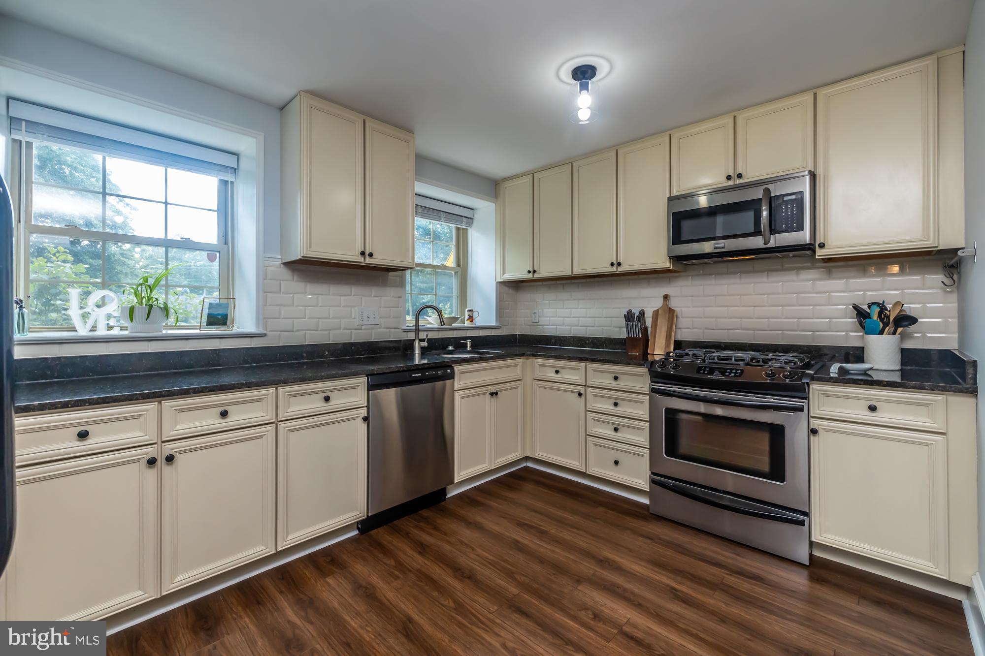 212 Idris Road, Unit Z1 Merion Station, PA 19066 - Photo 21 of 35 a kitchen with granite countertop white cabinets and white stainless steel appliances