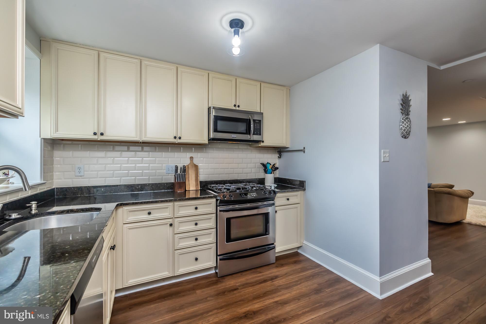 212 Idris Road, Unit Z1 Merion Station, PA 19066 - Photo 22 of 35 a kitchen with granite countertop a stove and a sink