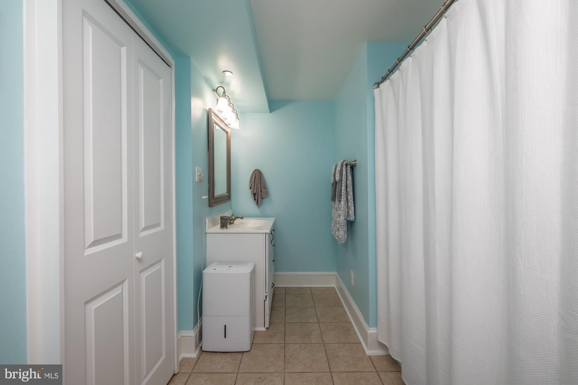 212 Idris Road, Unit Z1 Merion Station, PA 19066 - Photo 24 of 35 a bathroom with sink a toilet and shower curtain