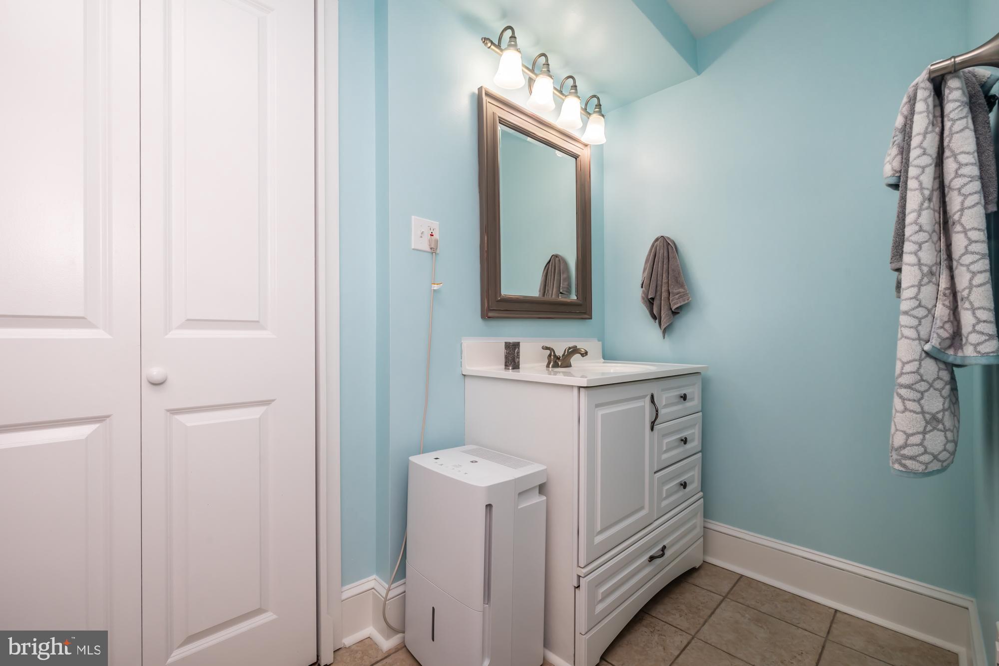 212 Idris Road, Unit Z1 Merion Station, PA 19066 - Photo 25 of 35 a bathroom with a sink a toilet and mirror
