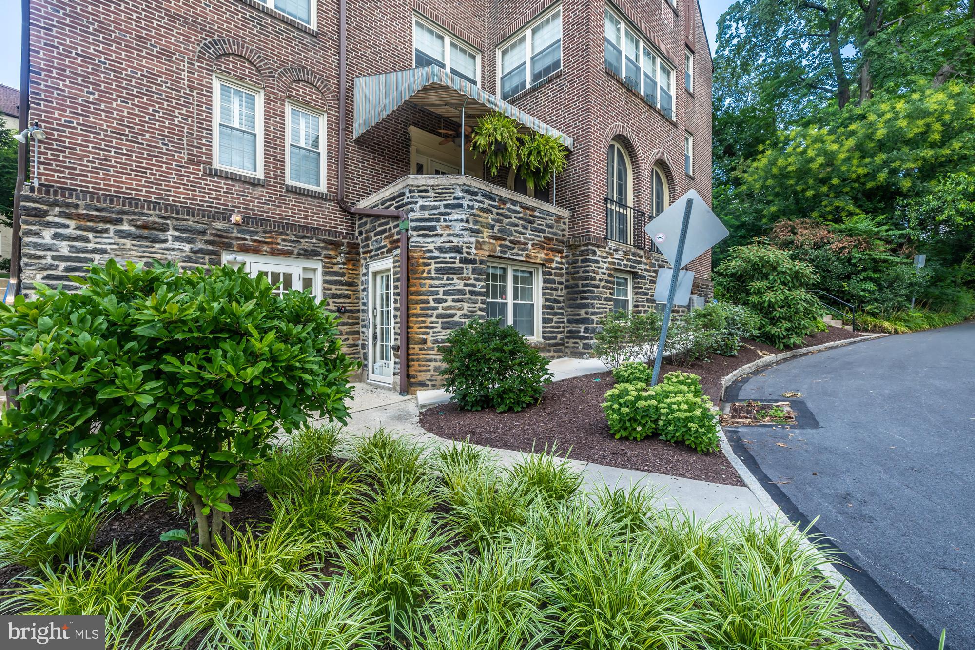 212 Idris Road, Unit Z1 Merion Station, PA 19066 - Photo 3 of 35 a front view of a house with a yard