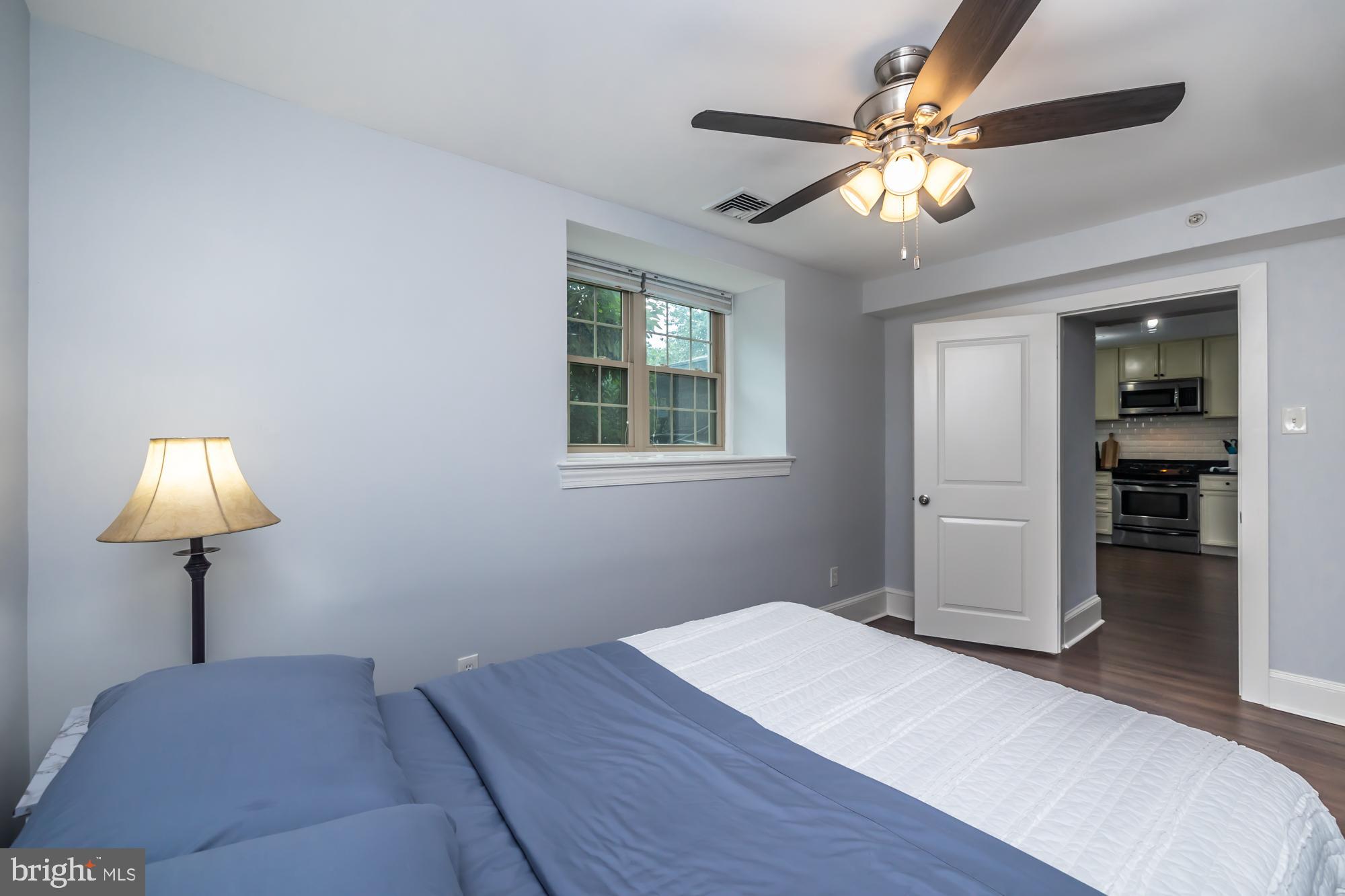 212 Idris Road, Unit Z1 Merion Station, PA 19066 - Photo 33 of 35 a bedroom with a bed and a chandelier