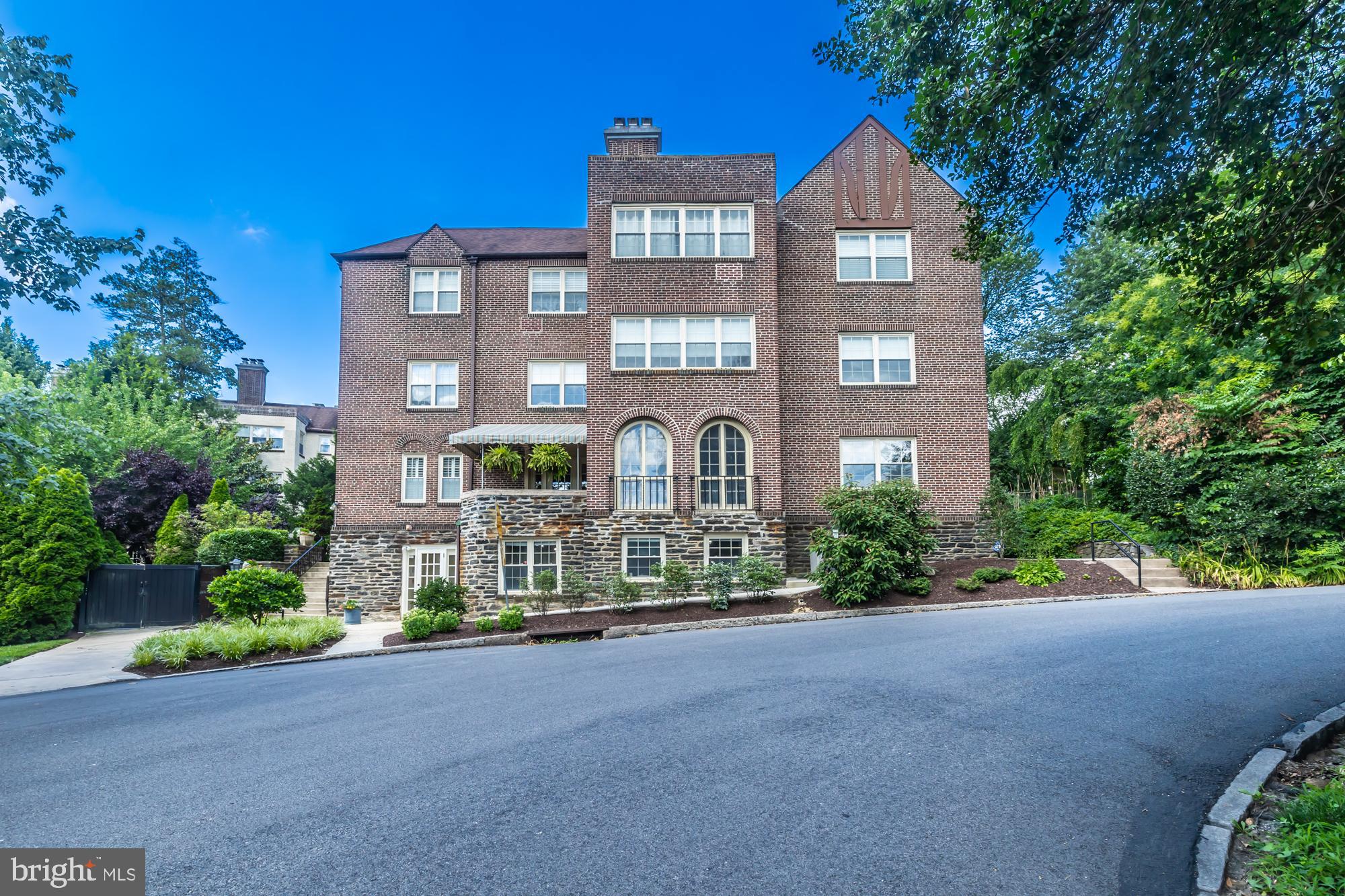 212 Idris Road, Unit Z1 Merion Station, PA 19066 - Photo 5 of 35 a front view of a residential apartment building with a yard