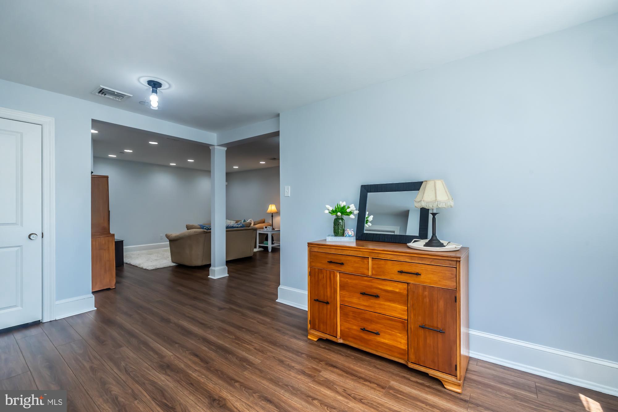 212 Idris Road, Unit Z1 Merion Station, PA 19066 - Photo 6 of 35 a room with furniture and wooden floor