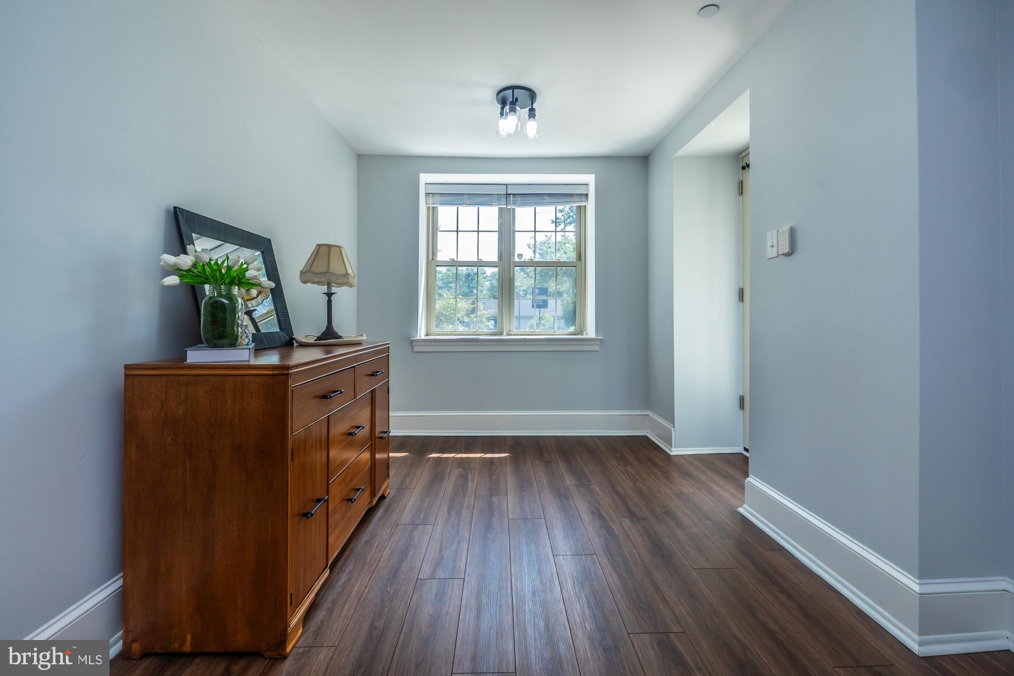 212 Idris Road, Unit Z1 Merion Station, PA 19066 - Photo 7 of 35 a view of a room with wooden floor and a window