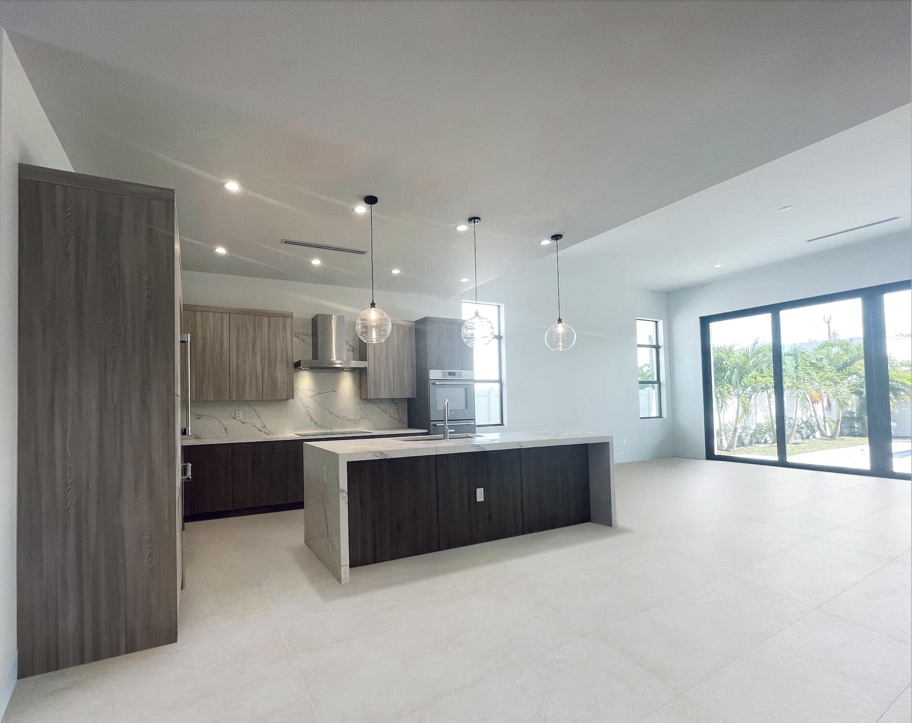 690 Jeffery Street Boca Raton, FL 33487 - Photo 1 of 8 a open kitchen with kitchen island a sink stainless steel appliances and cabinets