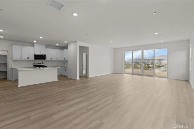 a view of a kitchen with a sink and a large window