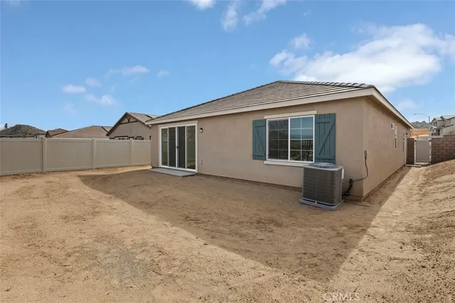 a view of a house with a backyard and garage