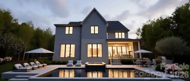 a front view of a house with swimming pool and furniture