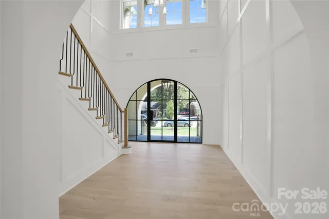 a kitchen with a refrigerator a sink and a wooden floor