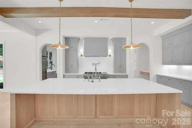 a kitchen with a sink cabinets and appliances