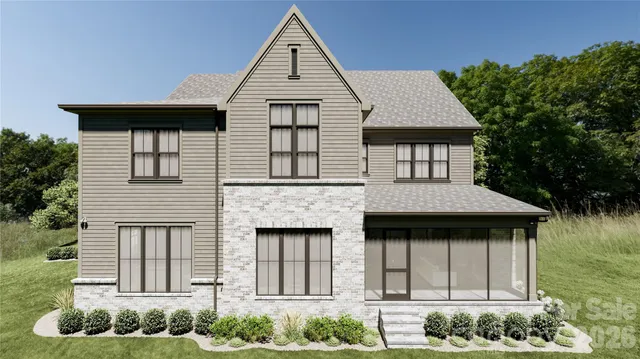 a front view of a house with yard and trees in the background