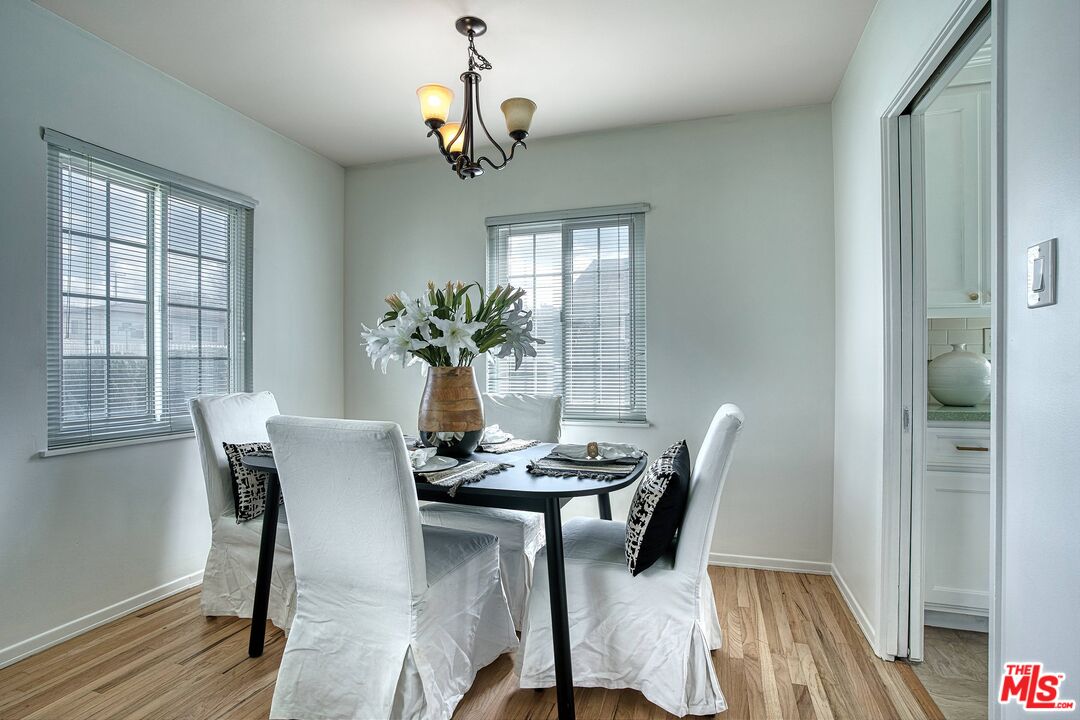95 Kenneth Street Camarillo, CA 93010 - Photo 6 of 25 a dining room with furniture potted plants and wooden floor