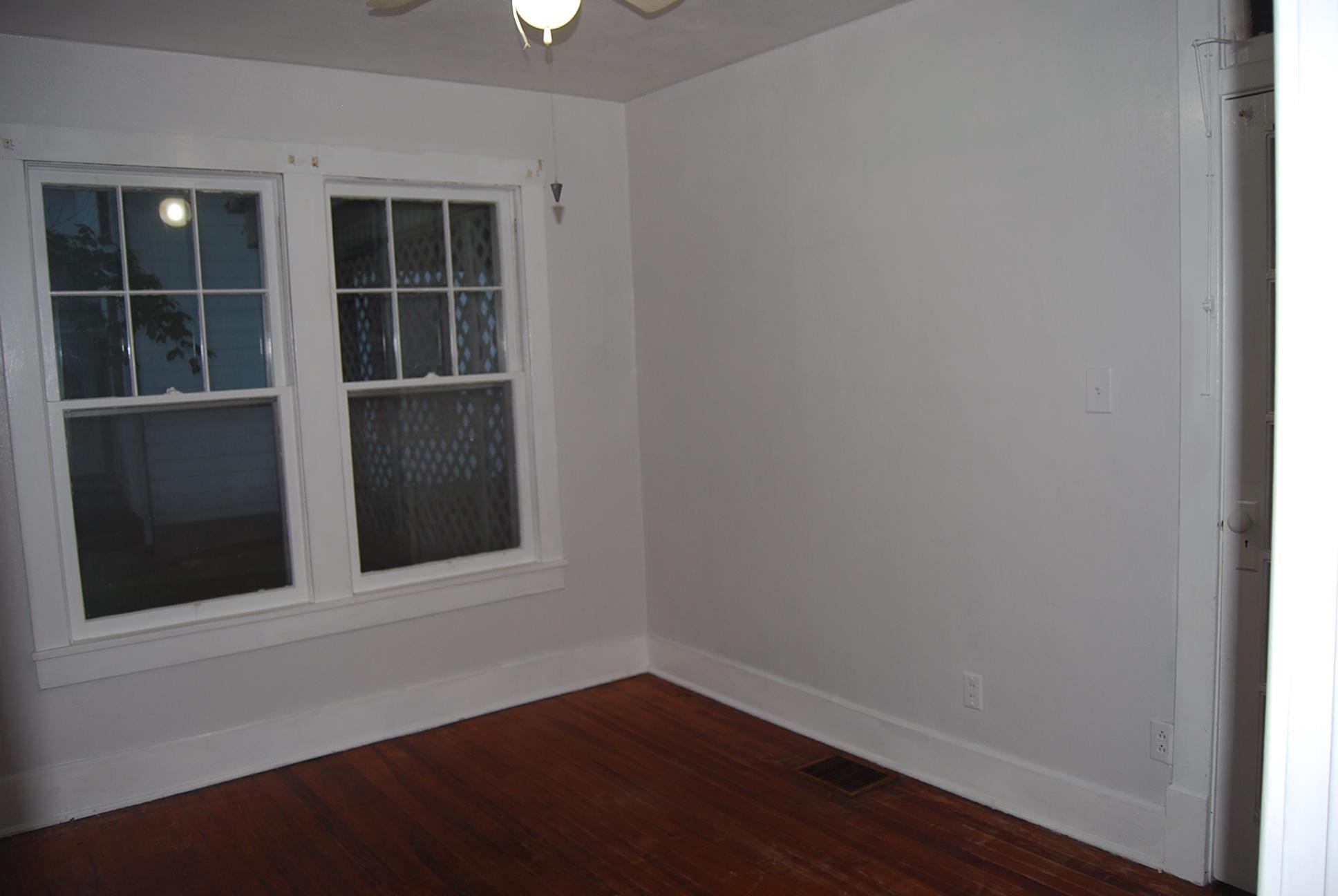 892 Virginia Avenue Goshen, VA 24439 - Photo 7 of 24 a view of empty room with wooden floor and fan