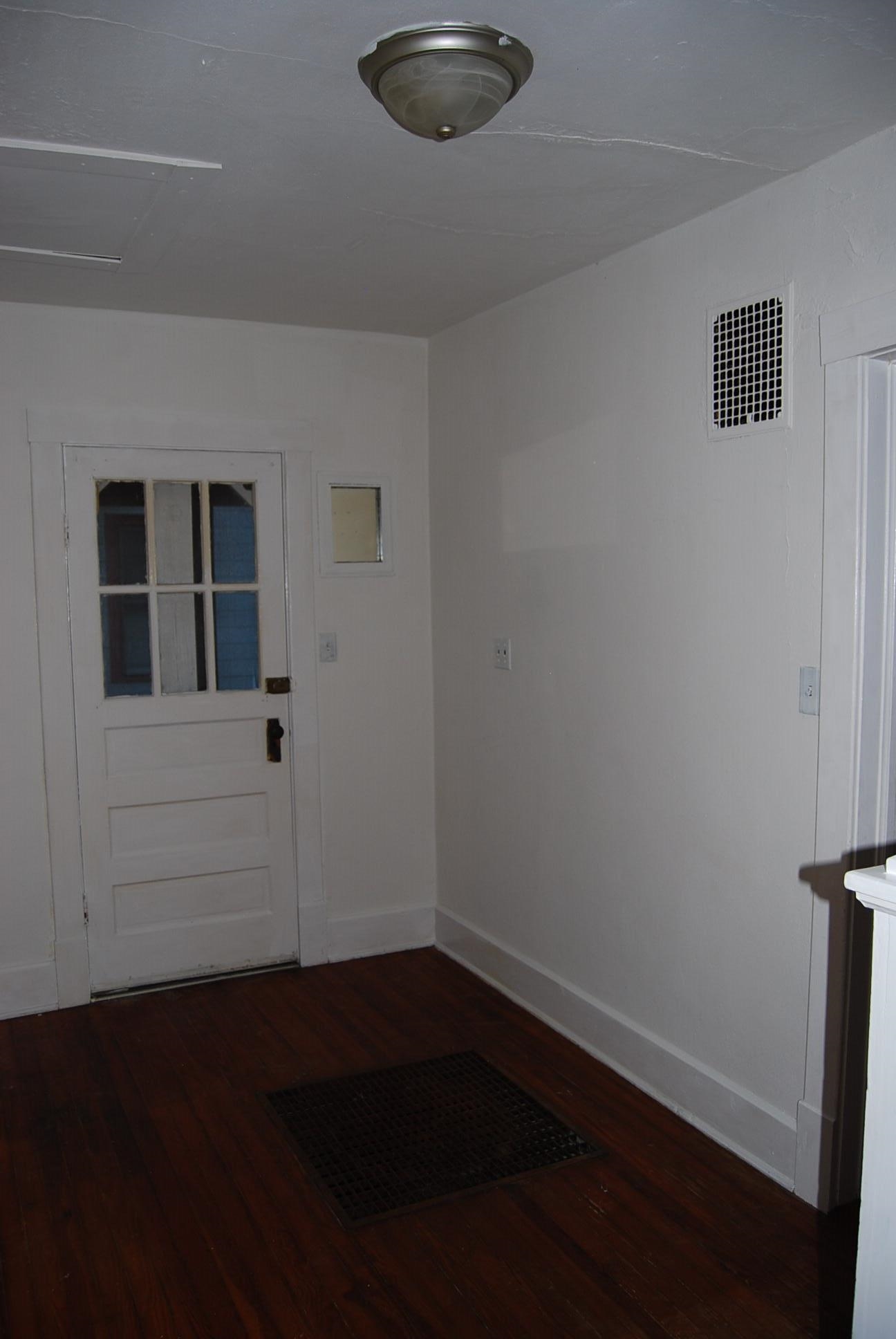 892 Virginia Avenue Goshen, VA 24439 - Photo 8 of 24 a view of a livingroom with wooden floor and a window