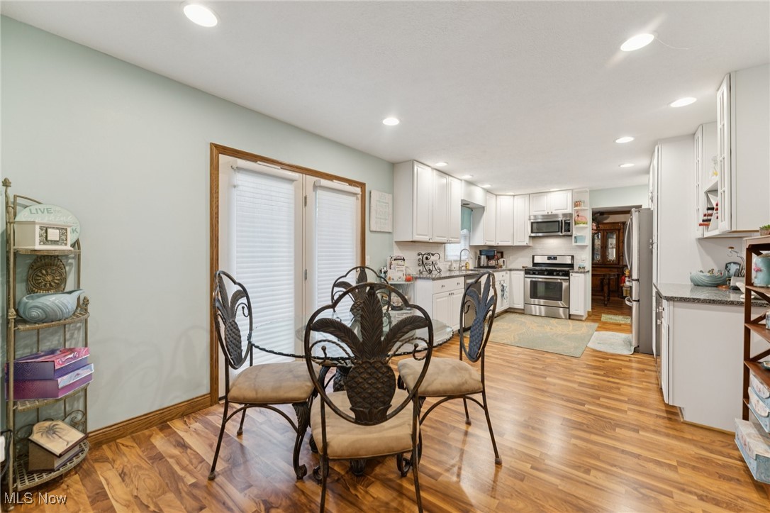 6930 Firestone Road Northeast Canton, OH 44721 - Photo 11 of 49 Dining area featuring light wood-style floors and recessed lighting