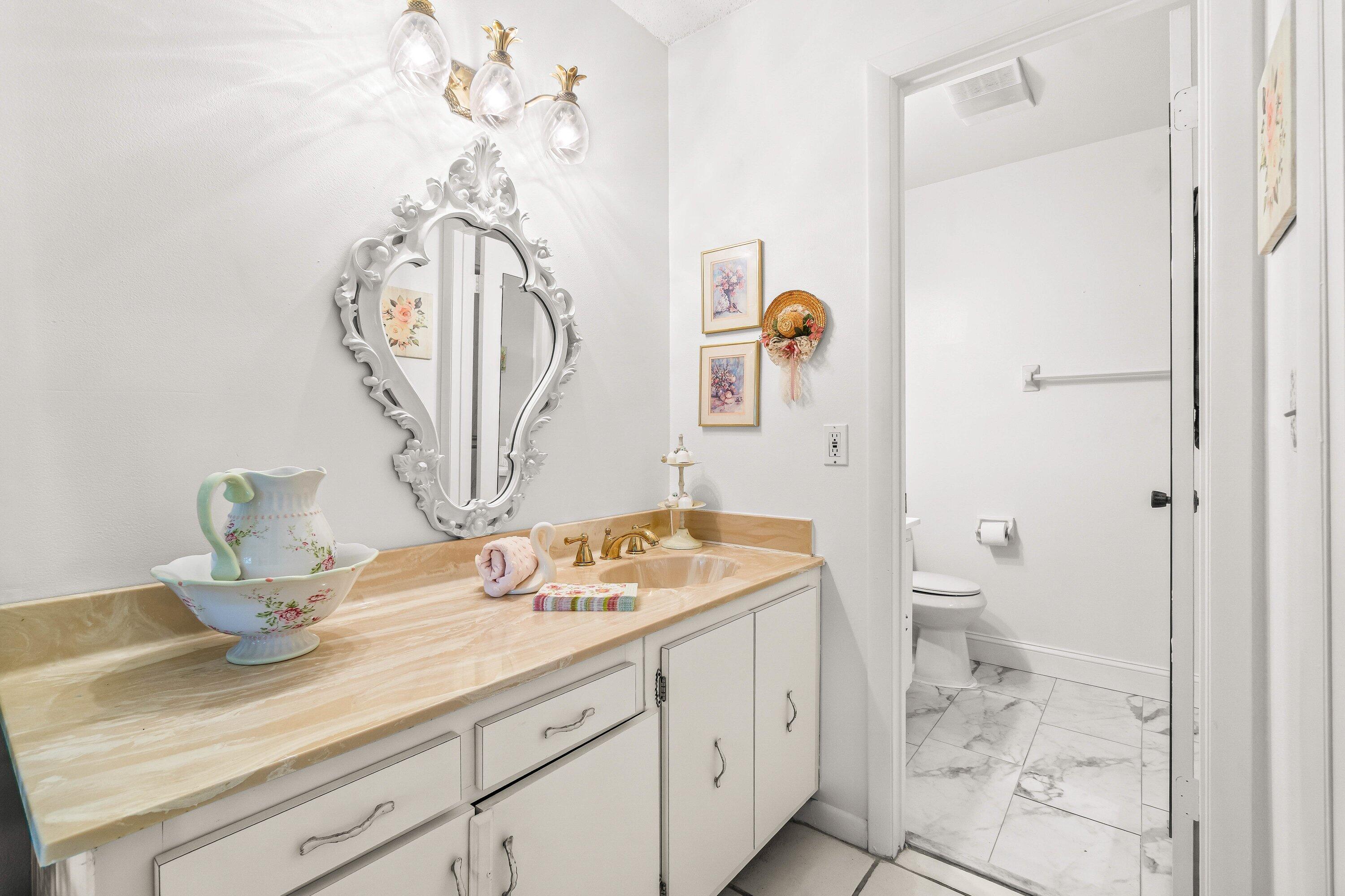 13735 Flora Place, Unit B Delray Beach, FL 33484 - Photo 16 of 28 a bathroom with a sink a toilet and shower