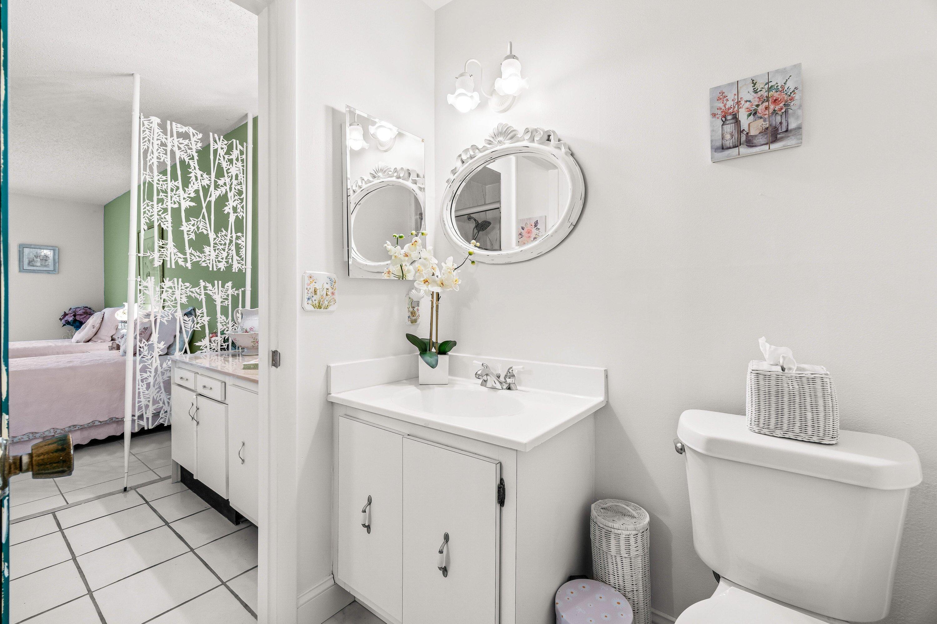 13735 Flora Place, Unit B Delray Beach, FL 33484 - Photo 17 of 28 a bathroom with a toilet sink and mirror