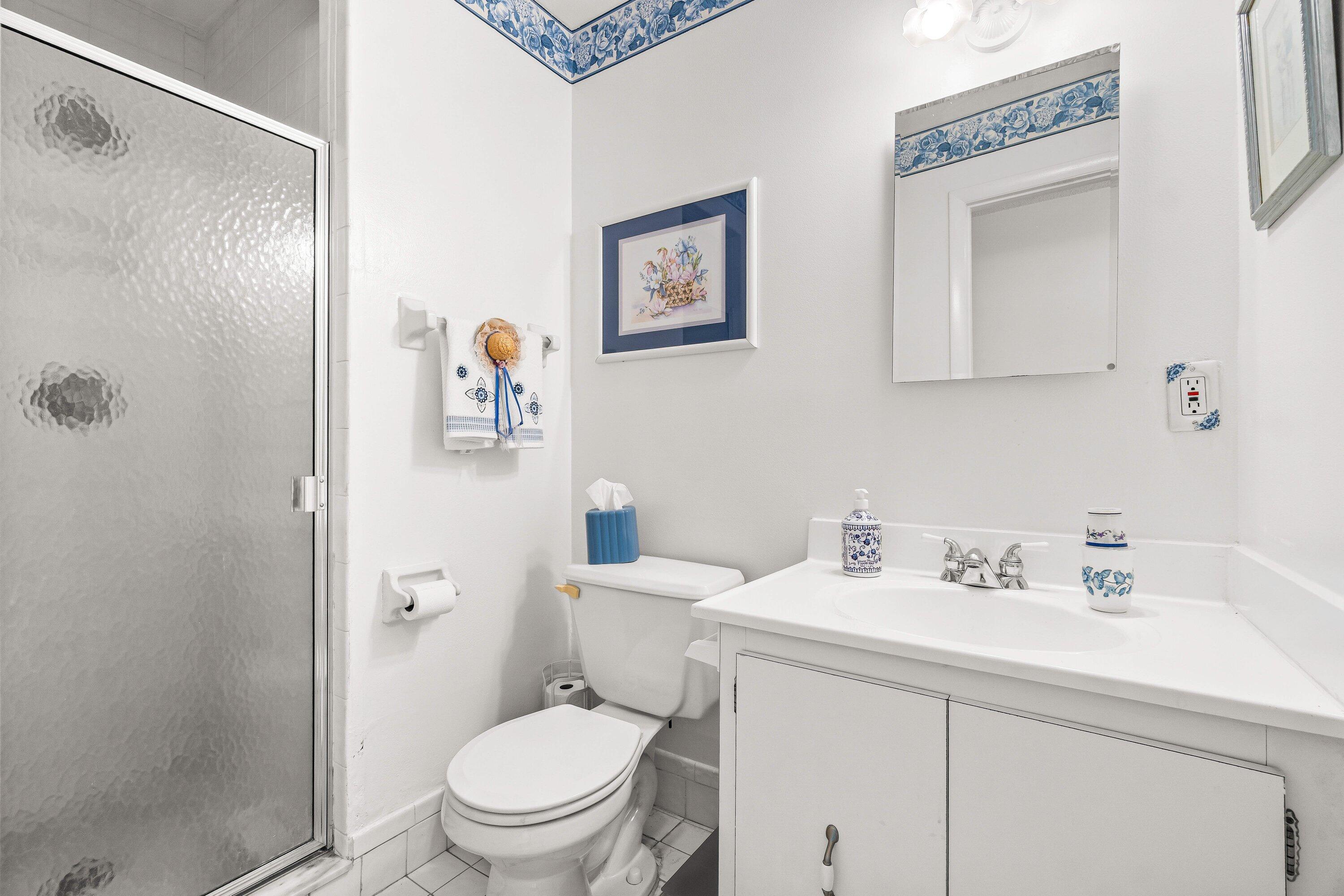 13735 Flora Place, Unit B Delray Beach, FL 33484 - Photo 20 of 28 a bathroom with a sink a toilet and shower