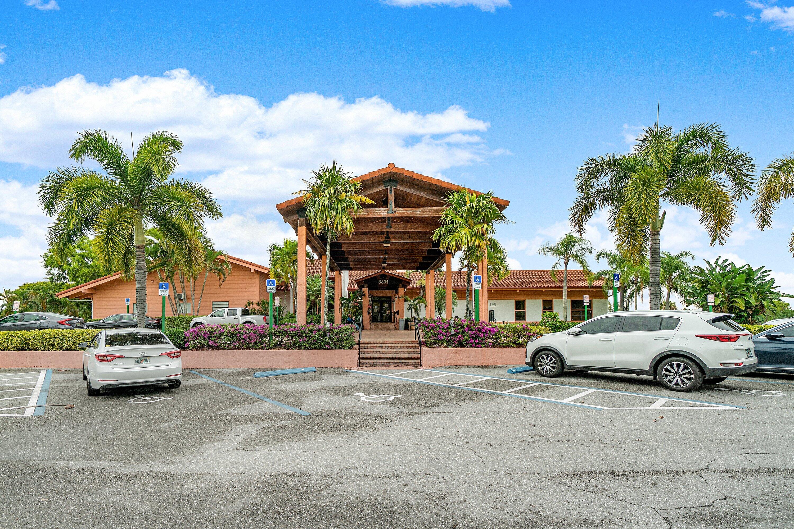 13735 Flora Place, Unit B Delray Beach, FL 33484 - Photo 22 of 28 a front view of a building with lot of cars and trees