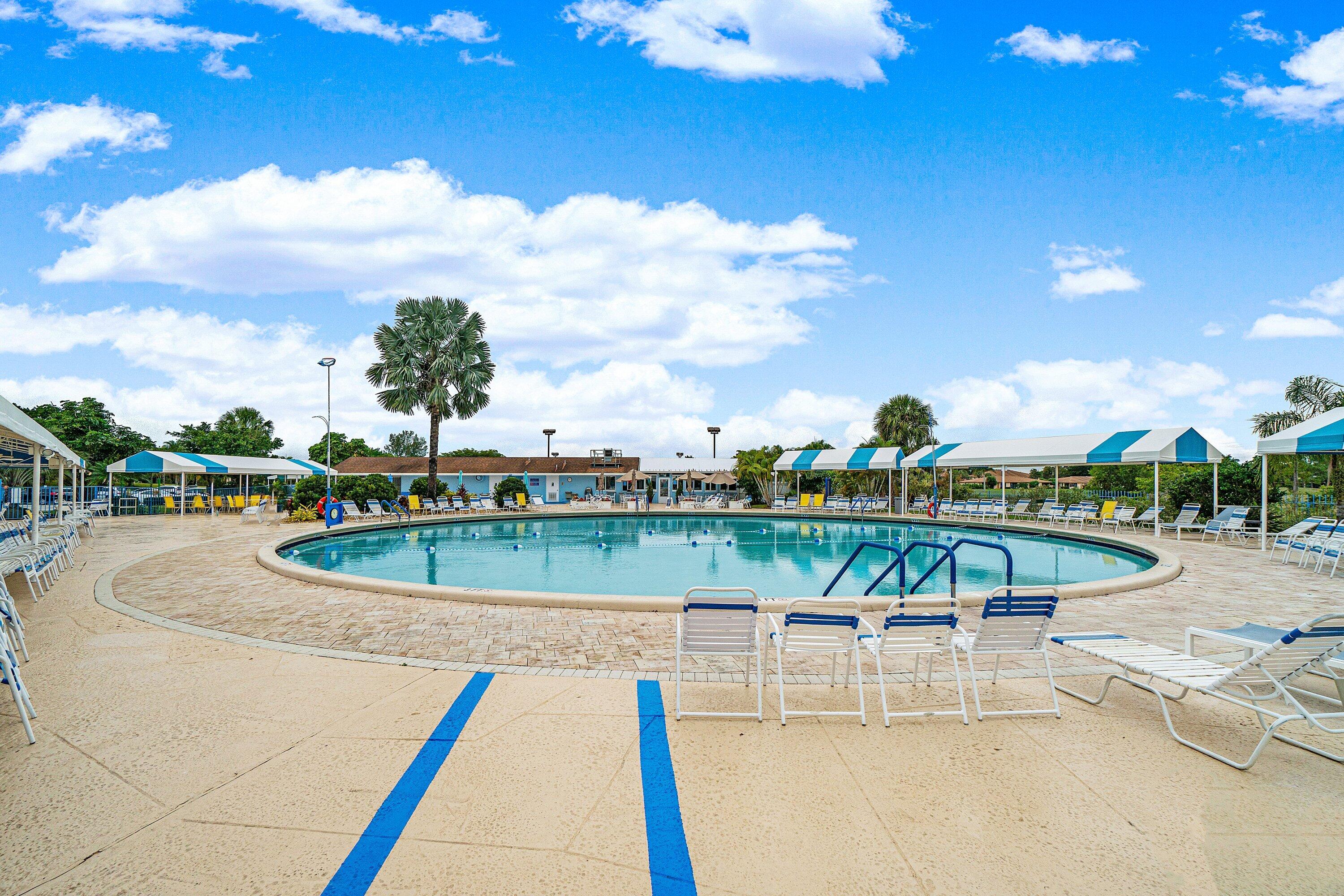 13735 Flora Place, Unit B Delray Beach, FL 33484 - Photo 24 of 28 a view of a swimming pool with a lounge chair