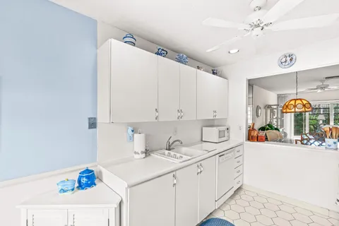a kitchen with a sink cabinets and window