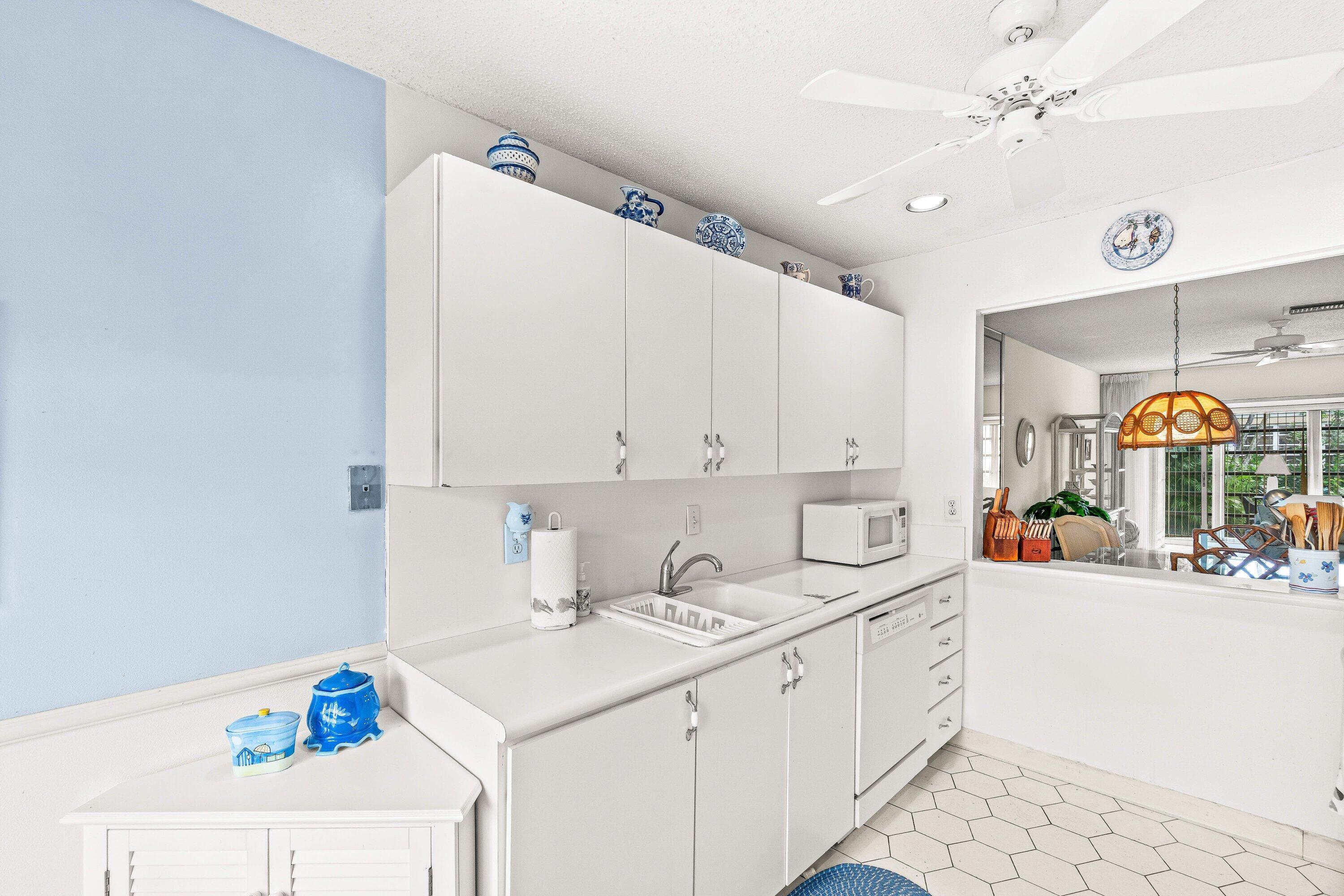 13735 Flora Place, Unit B Delray Beach, FL 33484 - Photo 3 of 28 a kitchen with a sink cabinets and window