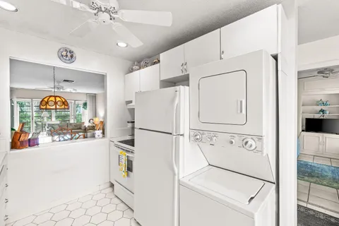 a white refrigerator freezer sitting in a kitchen