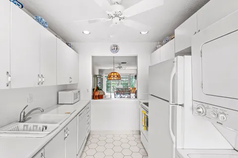a kitchen with a refrigerator a stove top oven a sink and dishwasher