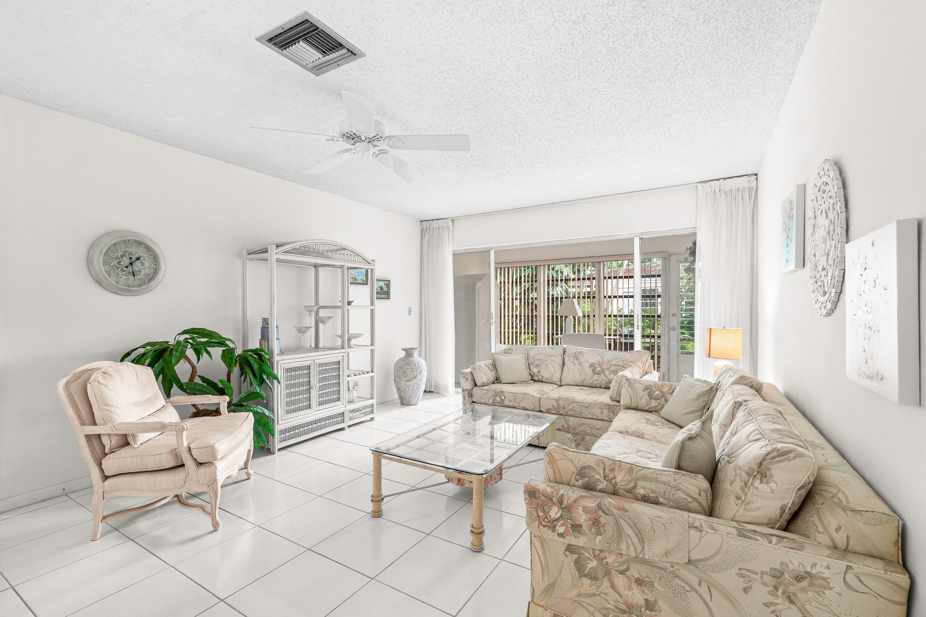 13735 Flora Place, Unit B Delray Beach, FL 33484 - Photo 7 of 28 a living room with furniture and a large window