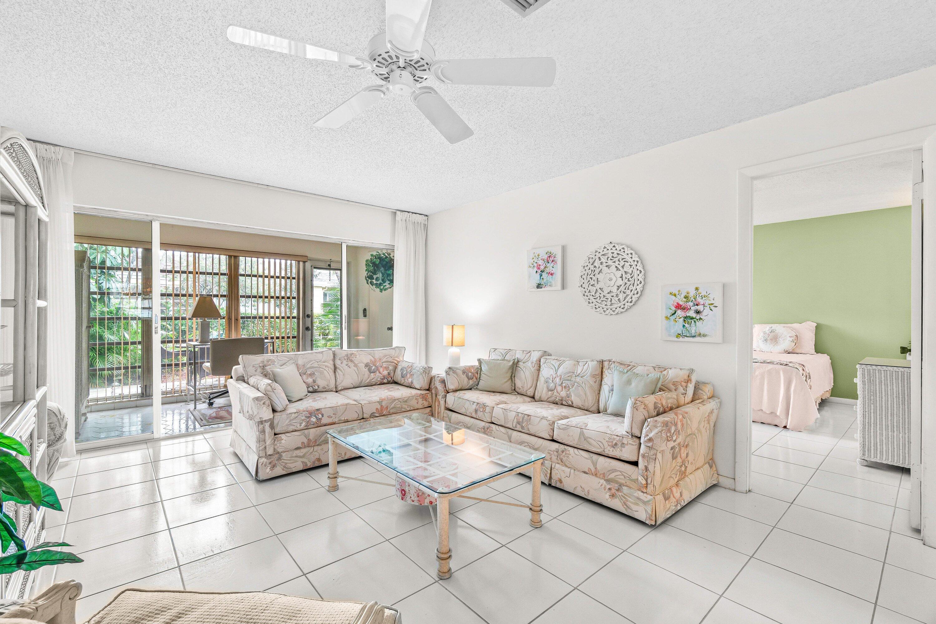 13735 Flora Place, Unit B Delray Beach, FL 33484 - Photo 8 of 28 a living room with furniture and a large window