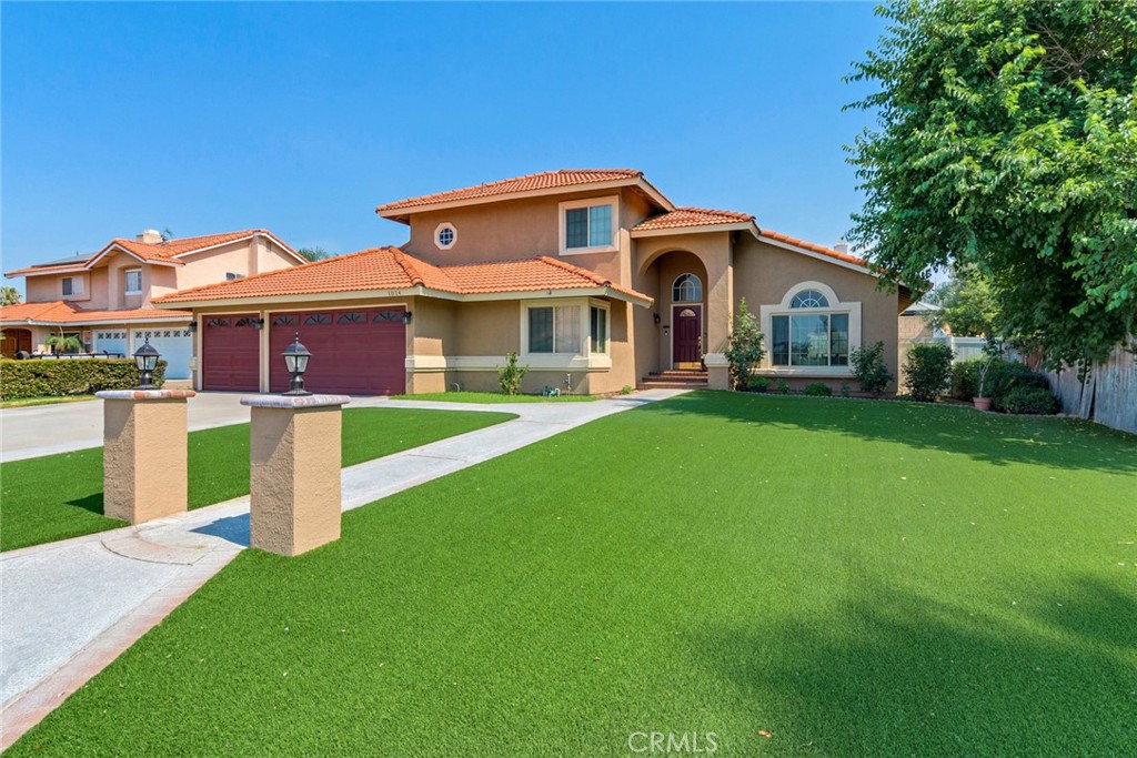 a front view of a house with a yard and garage