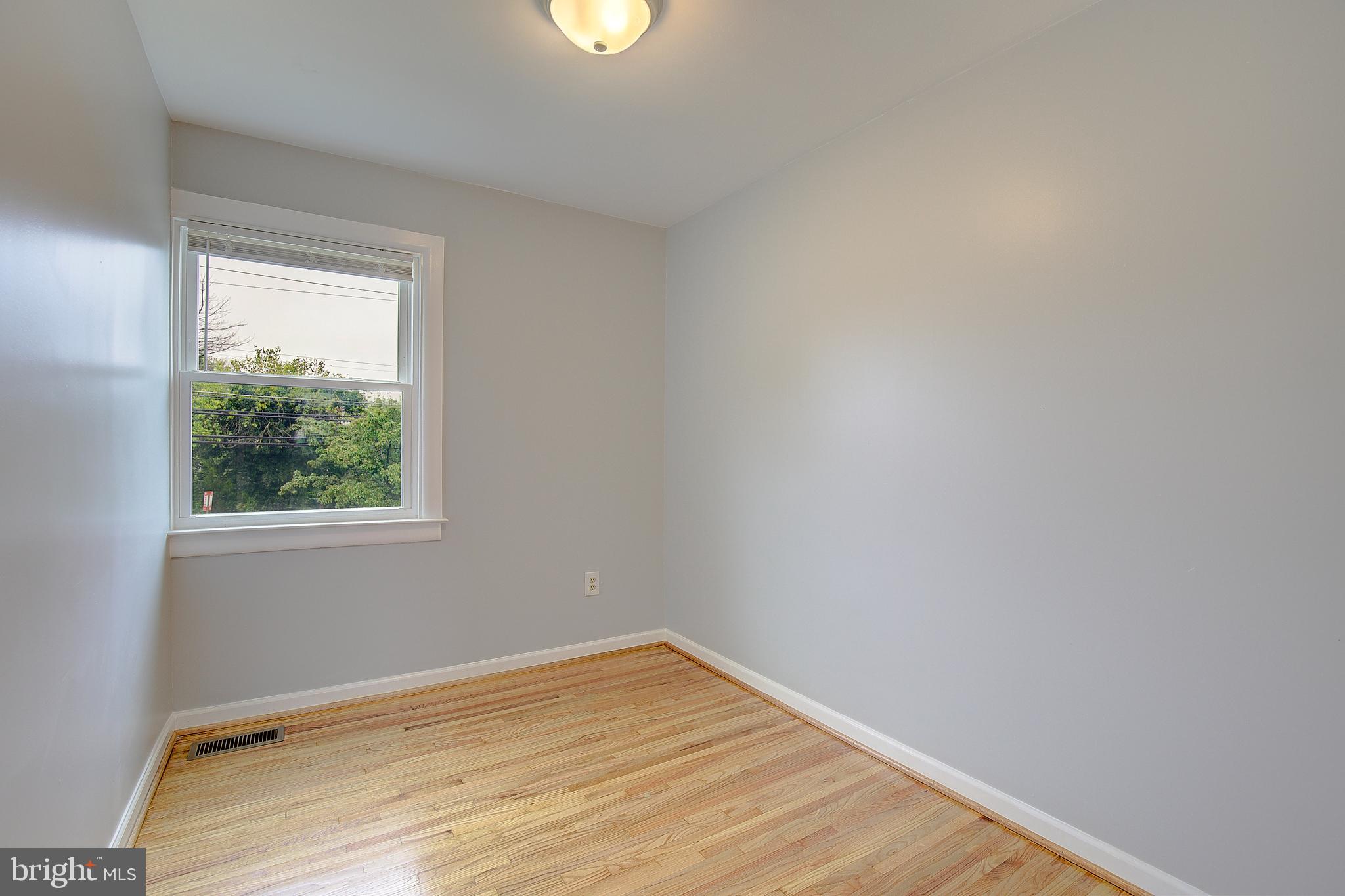4330 Annapolis Road Baltimore, MD 21227 - Photo 16 of 34 a view of an empty room with wooden floor and a window