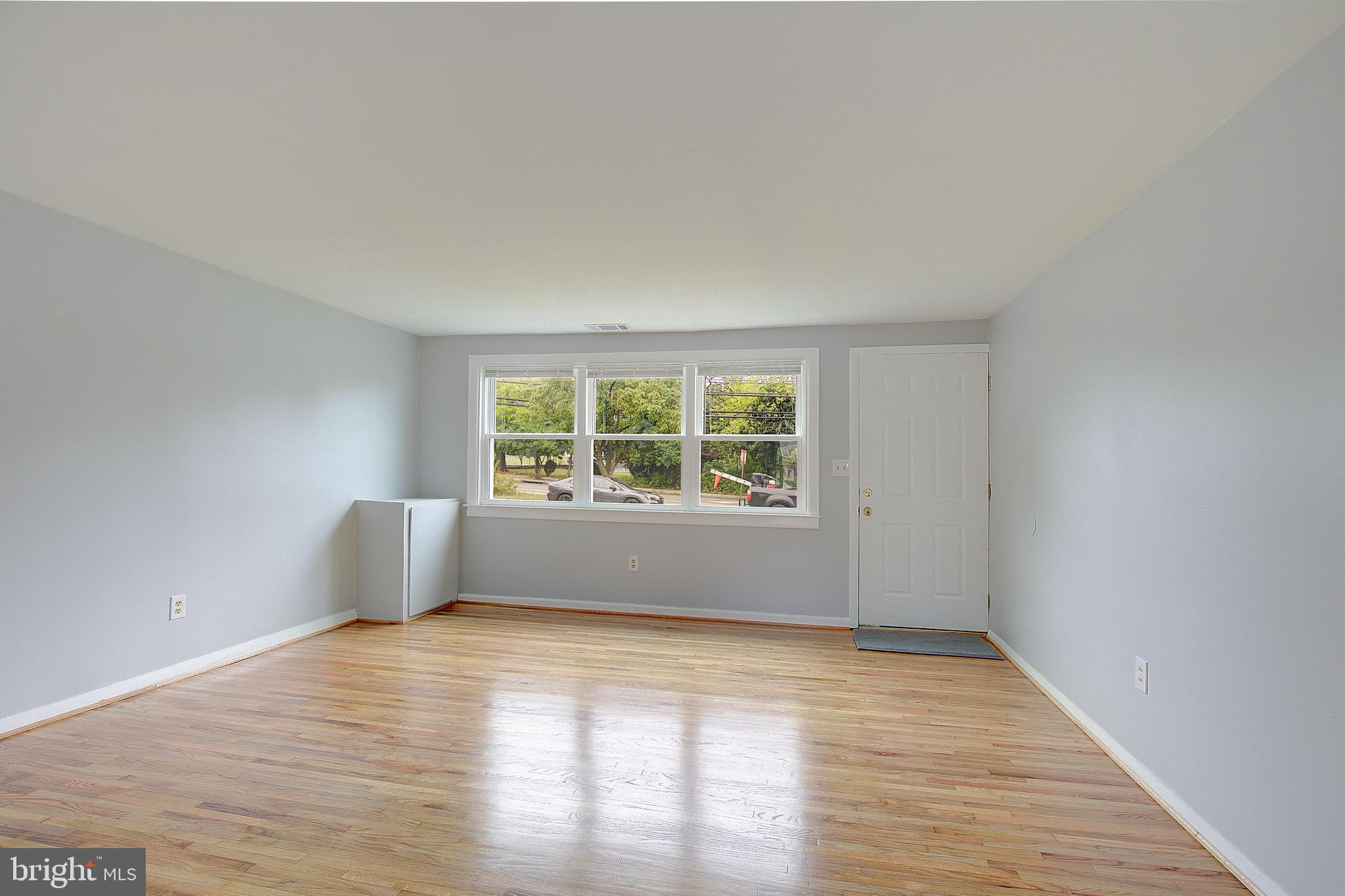 4330 Annapolis Road Baltimore, MD 21227 - Photo 7 of 34 wooden floor in an empty room with a window