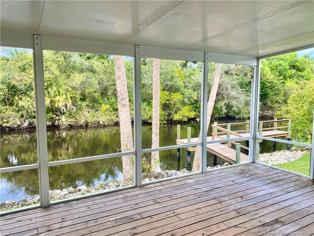 625 Southwest Salerno Road Stuart, FL 34997 - Photo 11 of 21 a view of a balcony with wooden floor and outdoor space