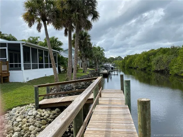 a view of a wooden deck with a lake view