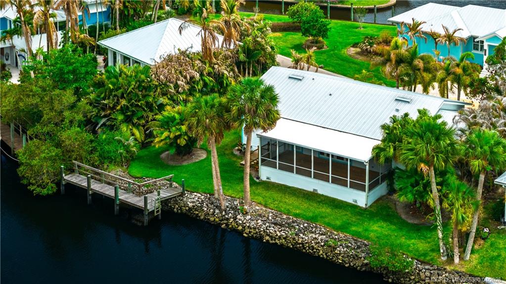 625 Southwest Salerno Road Stuart, FL 34997 - Photo 18 of 21 an aerial view of a house with swimming pool and garden