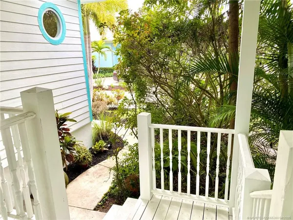 a view of a balcony with wooden fence and floor