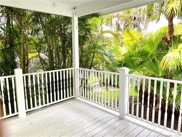 a view of a balcony with wooden floor