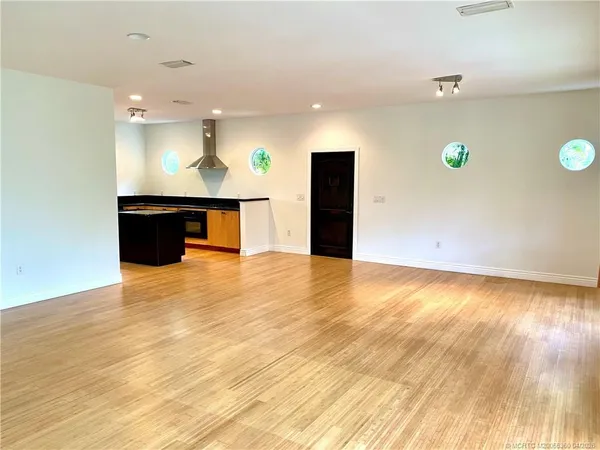 a view of a room with wooden floor