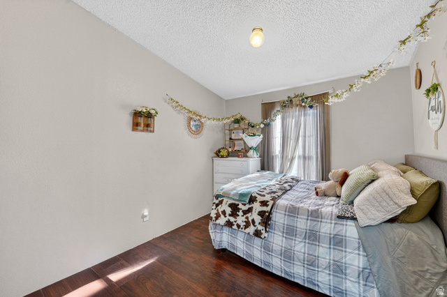 269 Mindella Way, Unit A Layton, UT 84041 - Photo 13 of 37 Bedroom with a textured ceiling and dark wood-type flooring