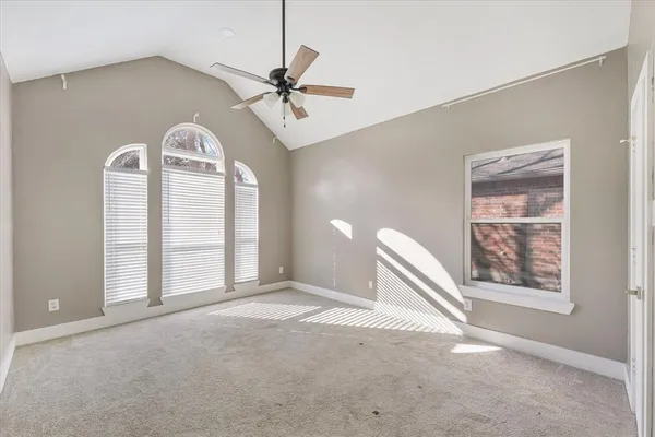 a view of a livingroom with a ceiling fan and window