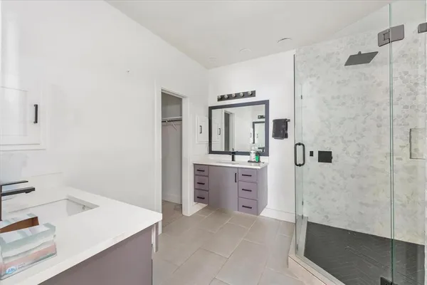 a bathroom with a sink a granite counter and a mirror
