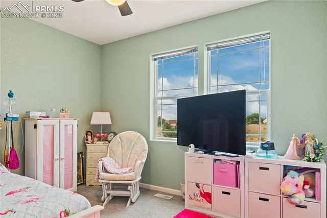 a bedroom with furniture and a flat screen tv