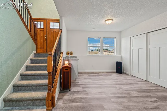 a view of an entryway with wooden floor