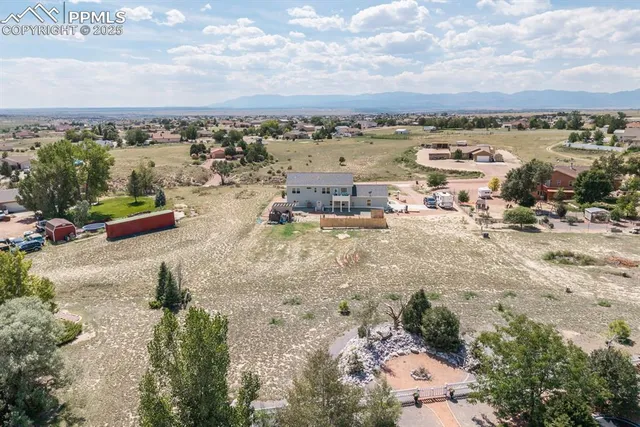 an aerial view of residential houses with outdoor space