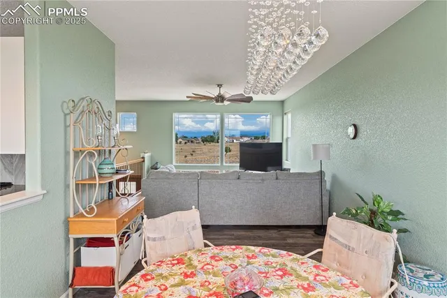 a living room with furniture and a chandelier