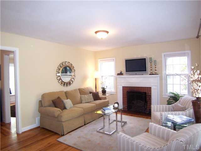 There are hardwood & tile floors throughout, & lots of closet space! Spacious LR offers a brick FP flanked by windows as well as a picture window. Living Room